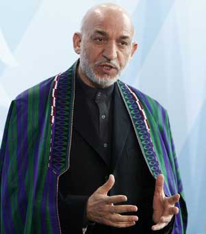 Britain says Karzai must deliver on clean-up pledges 