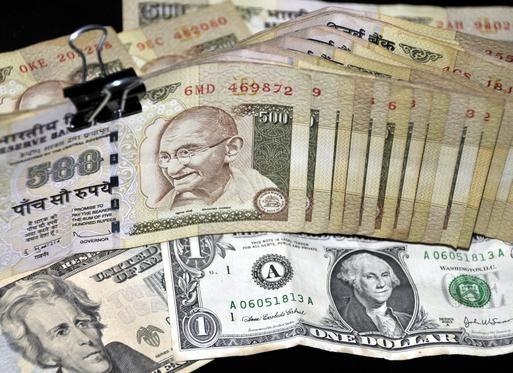 Indian rupee falls below 57 against the dollar